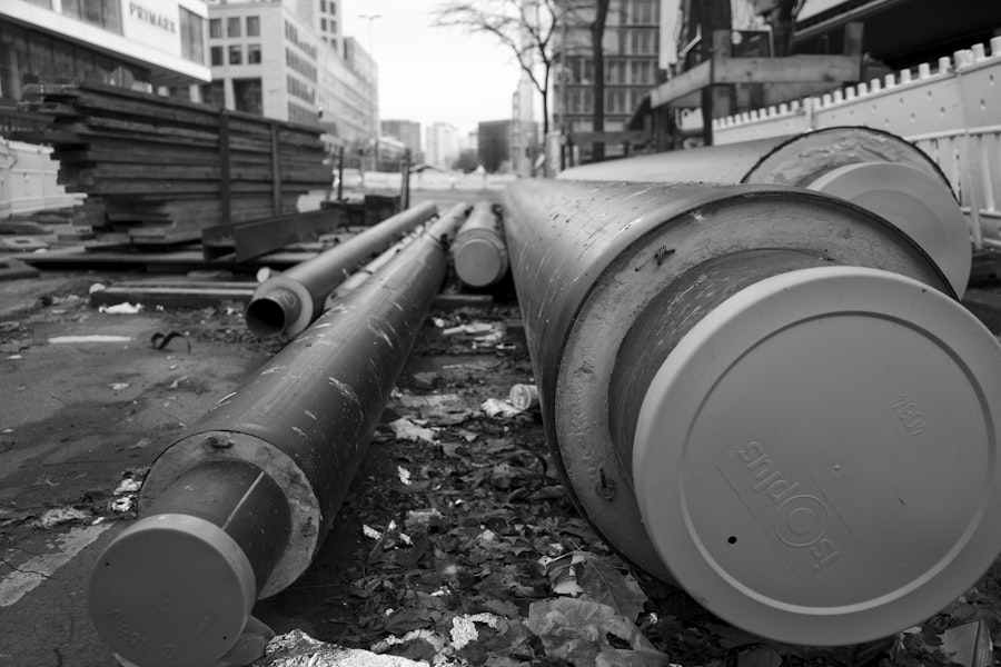 Large concrete sewer pipes laid out at a construction site