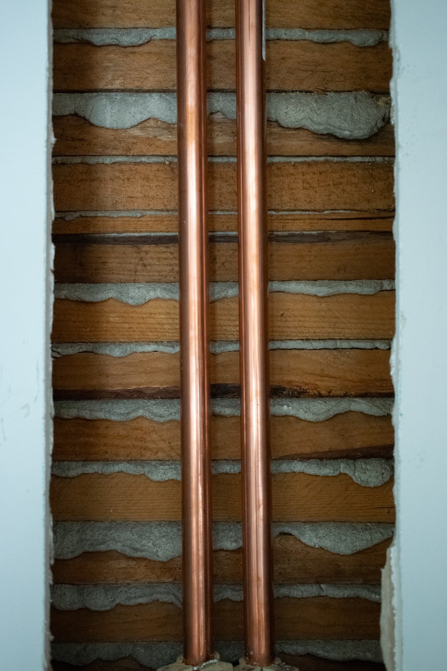 Two clean copper supply lines running through wall framing during a new-build rough-in